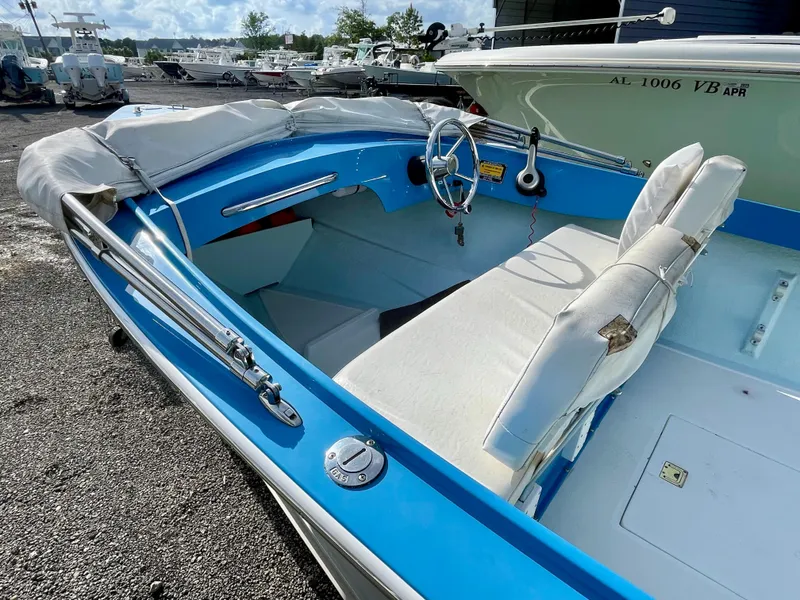 Slide: The Image of 1979 Negus 17 boat with blue and white interior, parked outdoors. - 5