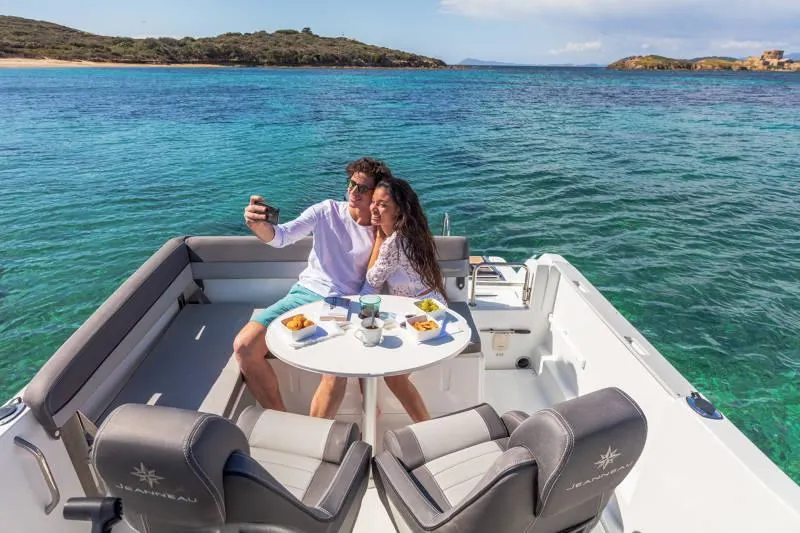 Slide: The Image of Couple enjoying a meal on a 2024 Jeanneau Leader 6.5 CC Series 3 boat. - 16