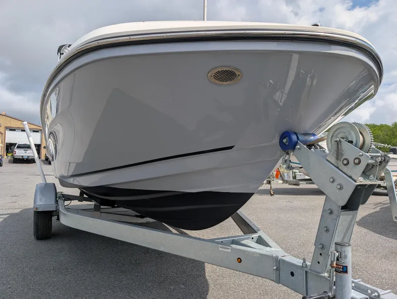 Slide: The Image of 2023 Bayliner VR5 Bowrider I/O on trailer, front view, parked outdoors. - 4