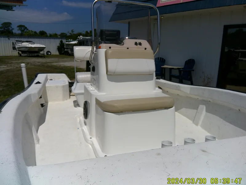 Slide: The Image of 2016 Key Largo 160 CC boat with center console and seating, parked outdoors. - 11