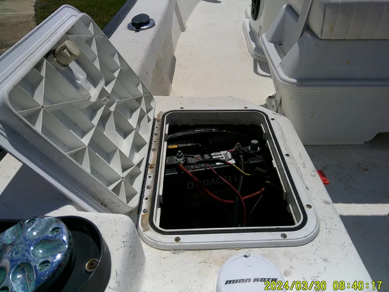 Slide: The Image of Open battery compartment on 2016 Key Largo 160 CC boat, showing wiring and connections. - 13
