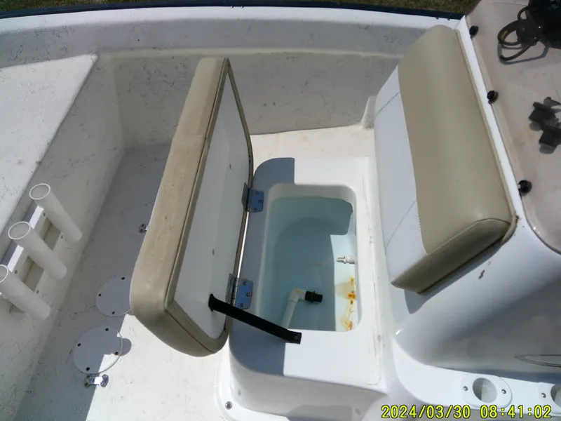 Slide: The Image of 2016 Key Largo 160 CC boat interior with open storage compartment and seating. - 15