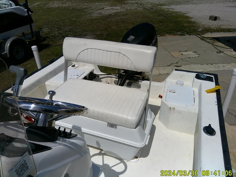 Slide: The Image of 2016 Key Largo 160 CC boat interior with steering wheel and seating. - 16