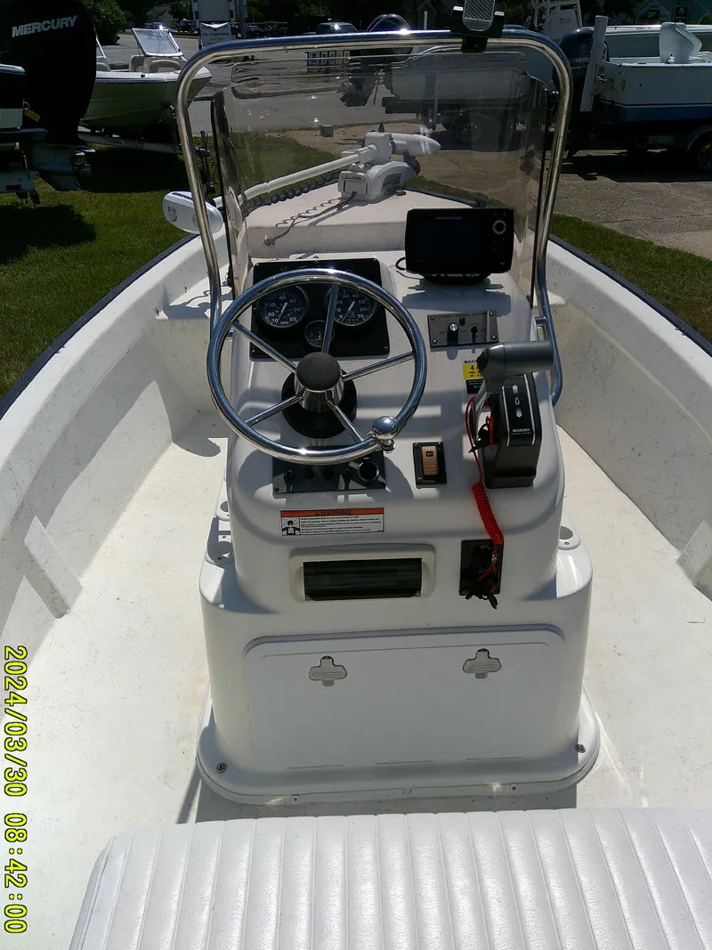 Slide: The Image of 2016 Key Largo 160 CC boat interior with steering console and controls. - 18