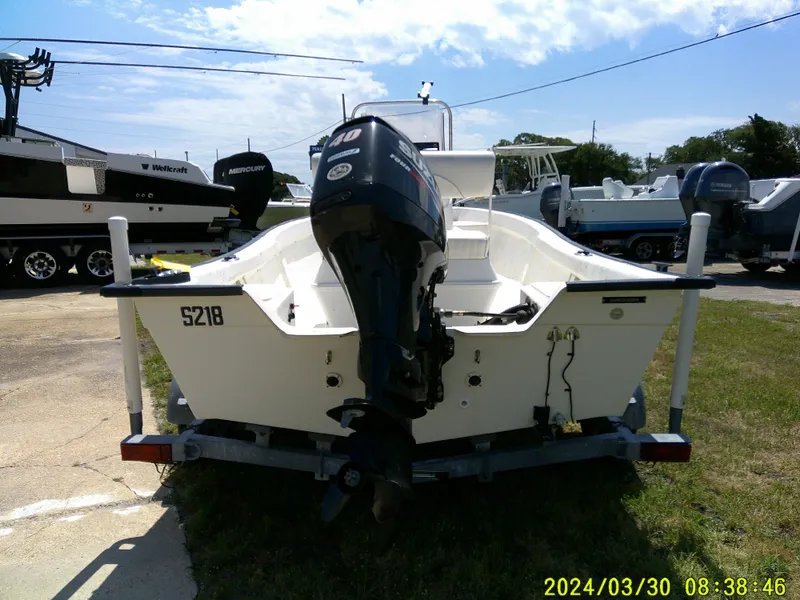 Slide: The Image of 2016 Key Largo 160 CC boat on trailer, rear view with outboard motor, parked outdoors. - 5