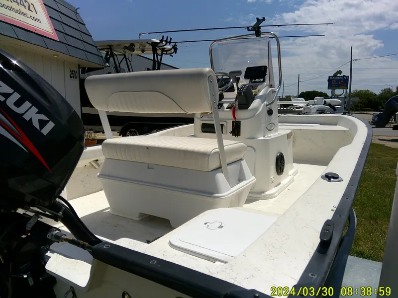 Slide: The Image of 2016 Key Largo 160 CC boat with Suzuki outboard motor, parked outdoors. - 6