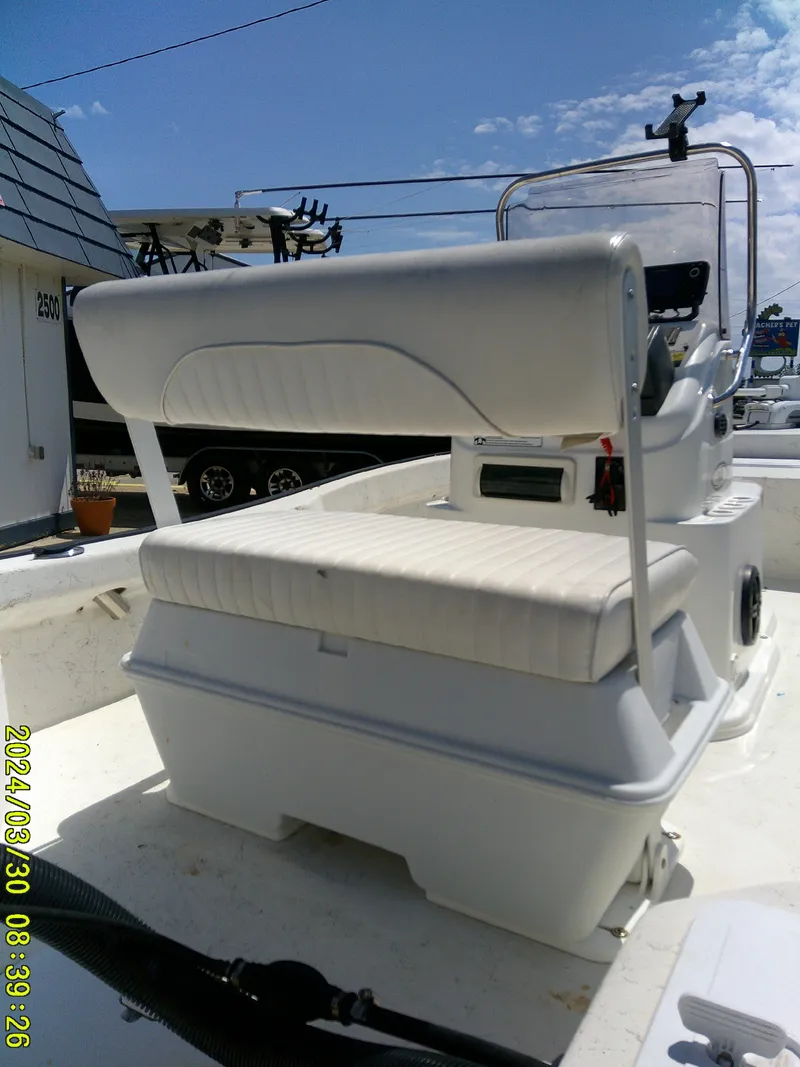 Slide: The Image of 2016 Key Largo 160 CC boat interior with cushioned seating and control panel. - 8