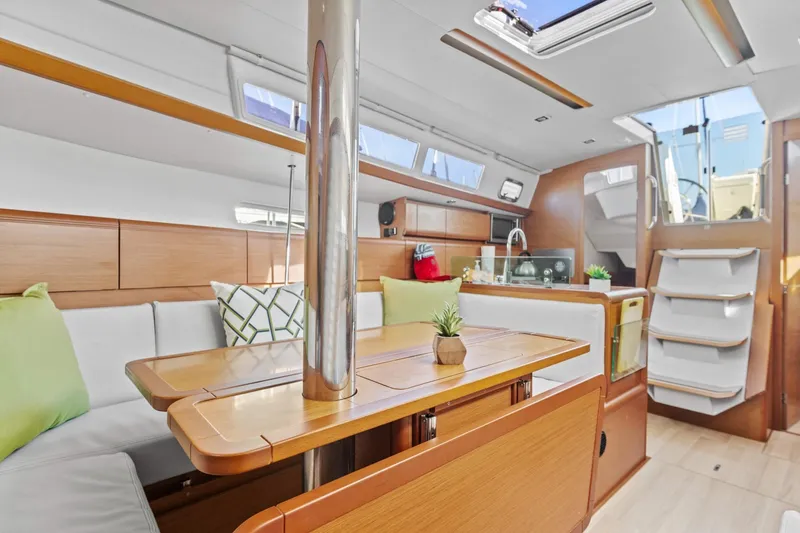 Slide: The Image of Interior of 2020 Jeanneau Sun Odyssey 389 sailboat, featuring modern wood finish and cozy seating. - 12