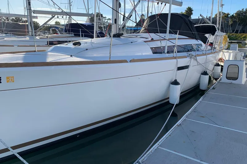 Slide: The Image of 2020 Jeanneau Sun Odyssey 389 sailboat docked at marina, side view. - 16