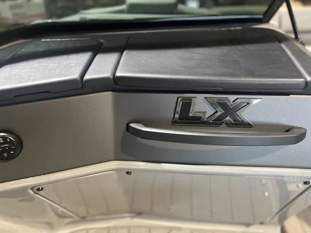 Slide: The Image of 2024 Manitou LX 23 dashboard with LX emblem and sleek design. - 10