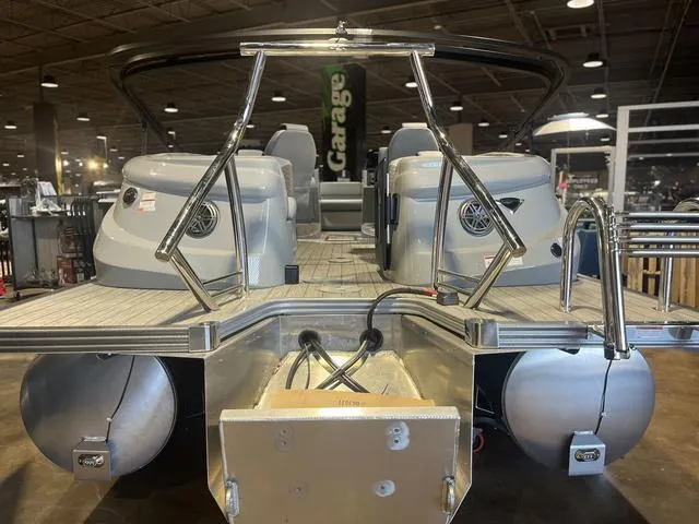 Slide: The Image of 2024 Manitou LX 23 RFXW pontoon boat with rear-facing seats and X-Treme windshield. - 4