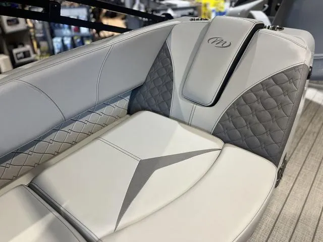 Slide: The Image of 2024 Manitou LX 23 RFXW boat seat with elegant gray and white upholstery design. - 5