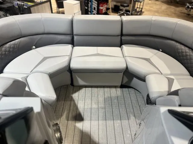 Slide: The Image of 2024 Manitou LX 23 RFXW boat interior with luxurious gray seating arrangement. - 7