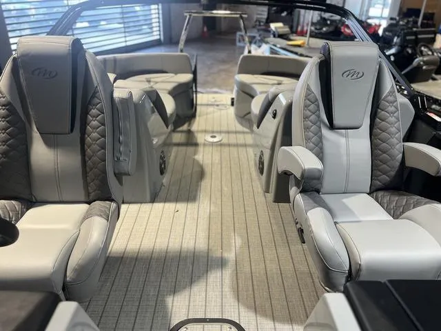 Slide: The Image of 2024 Manitou LX 23 RFXW boat interior with luxurious seating and modern design. - 8