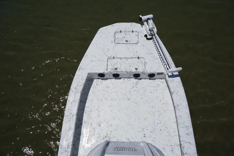 Slide: The Image of 2019 Haynie 23 Super Cat boat deck with trolling motor on calm water. - 15