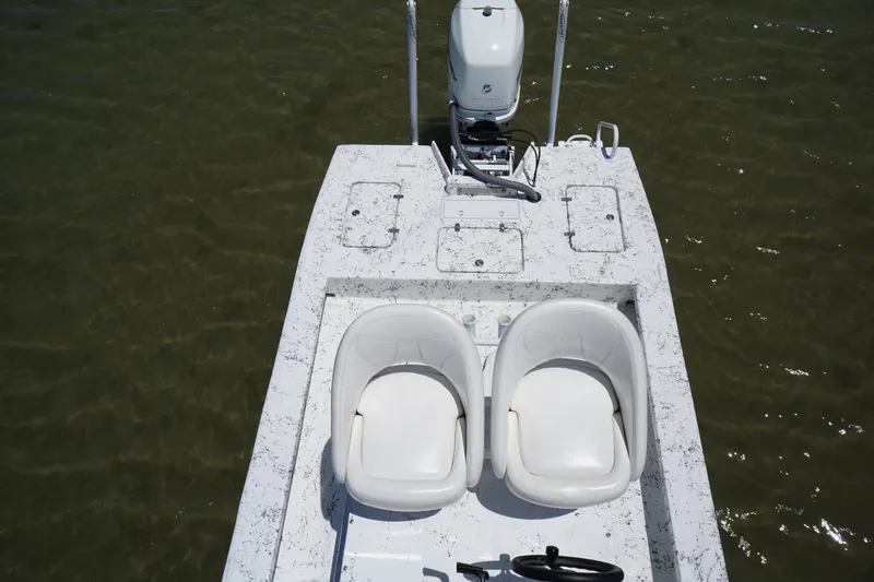 Slide: The Image of 2019 Haynie 23 Super Cat boat with dual seats and motor on calm water. - 16