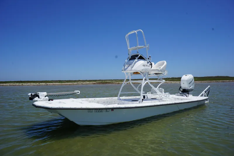 Slide: The Image of 2019 Haynie 23 Super Cat boat on calm water under clear blue sky. - 7