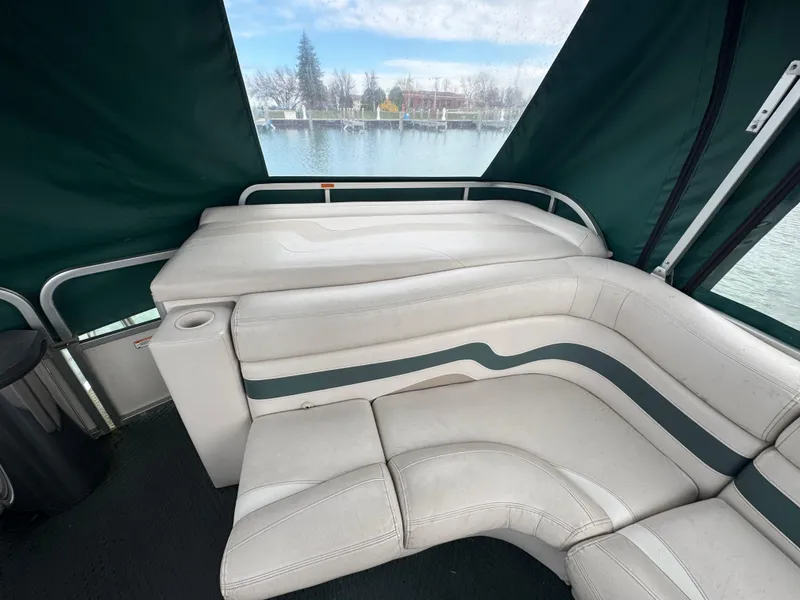 Slide: The Image of 2007 Manitou Legacy boat interior with white seating and lake view. - 10