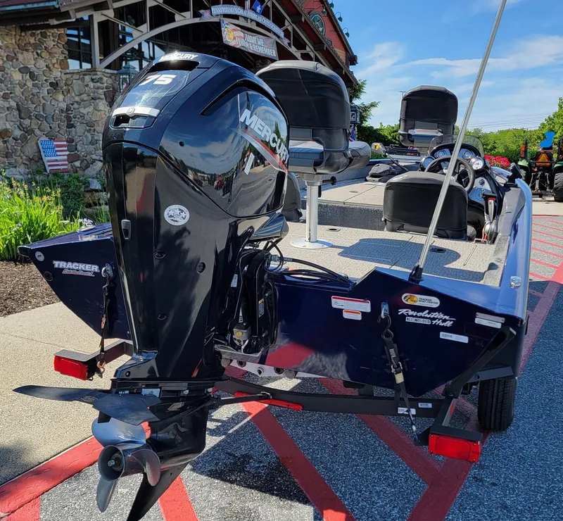 Slide: The Image of 2021 Tracker Pro Team 175 TF boat with Mercury engine, parked outdoors. - 3