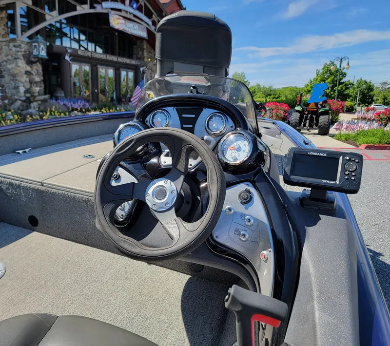 Slide: The Image of 2021 Tracker Pro Team 175 TF boat dashboard with steering wheel and navigation system. - 4