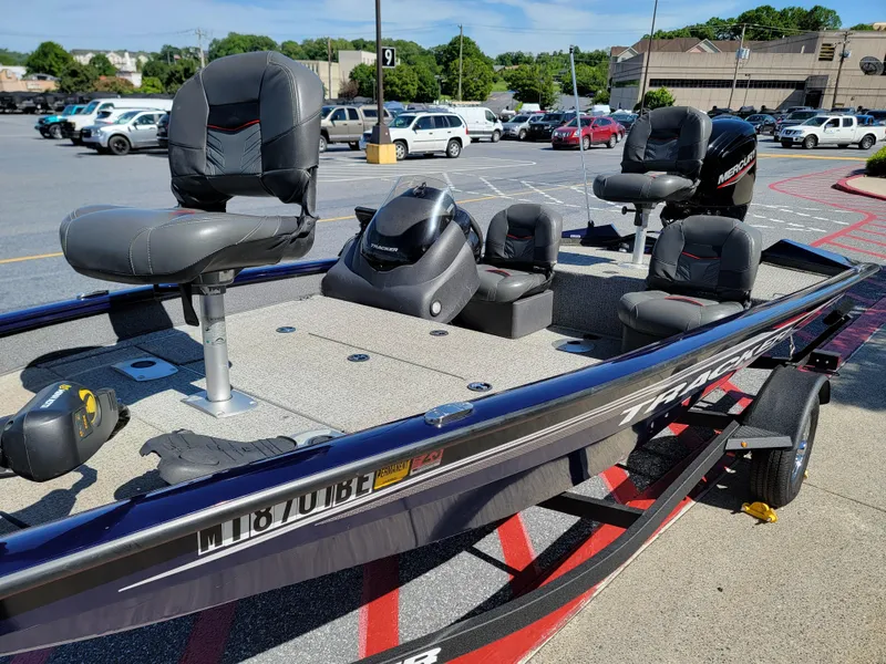 Slide: The Image of 2021 Tracker Pro Team 175 TF boat in parking lot, featuring multiple seats and a sleek design. - 6