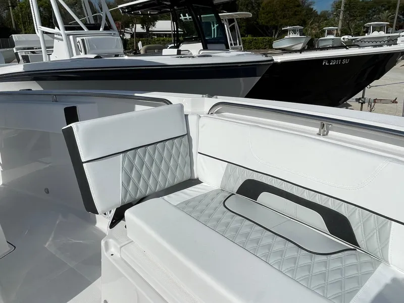 Slide: The Image of 2025 Blackfin 252CC boat interior with white and gray seating, featuring diamond-patterned upholstery. - 11