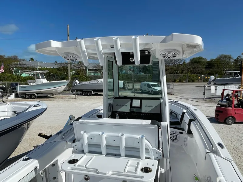 Slide: The Image of 2025 Blackfin 252CC boat with center console and modern design in a marina setting. - 19