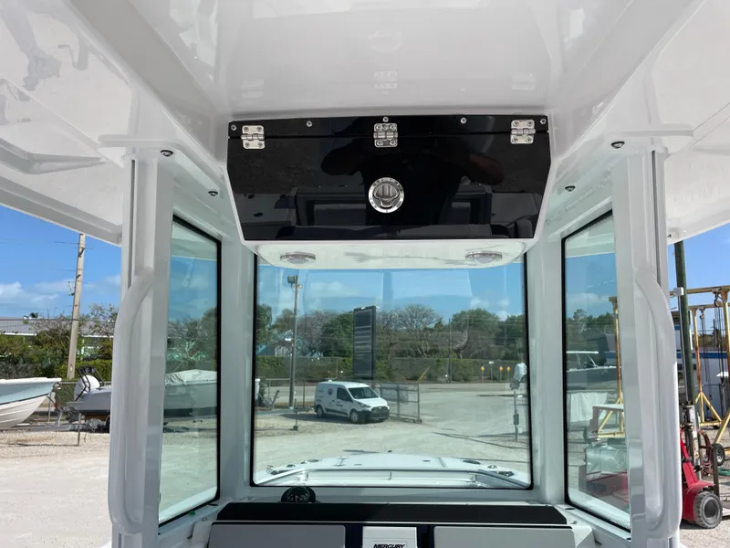 Slide: The Image of 2025 Blackfin 252CC boat interior with glass windows and overhead storage. - 20