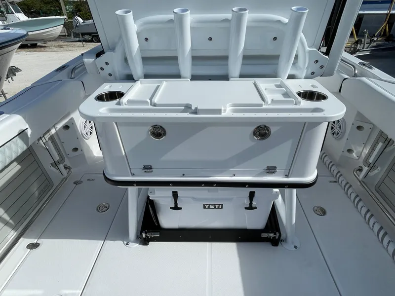 Slide: The Image of 2025 Blackfin 252CC boat deck with fishing rod holders and Yeti cooler. - 21