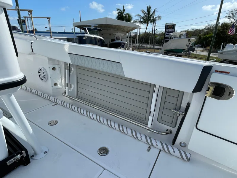 Slide: The Image of 2025 Blackfin 252CC boat deck with storage compartment and sleek design. - 27