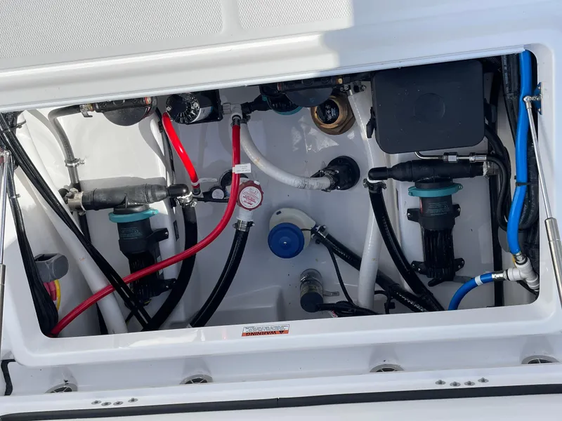 Slide: The Image of 2025 Blackfin 252CC boat plumbing system with various hoses and fittings. - 29