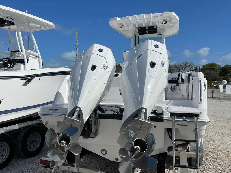 Slide: The Image of 2025 Blackfin 252CC boat with dual outboard engines, displayed outdoors. - 3