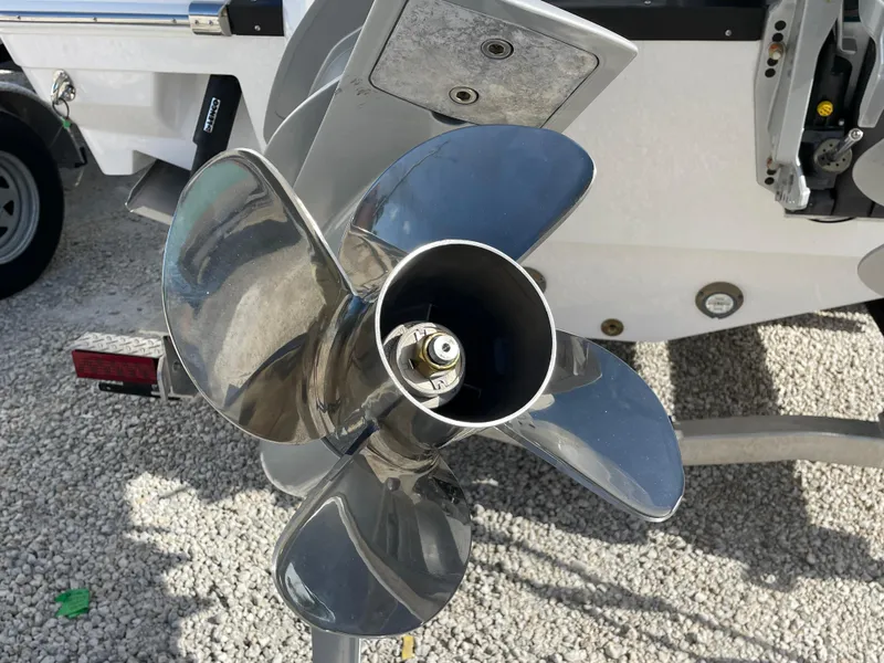 Slide: The Image of Propeller of 2025 Blackfin 252CC boat on gravel surface, close-up view. - 36