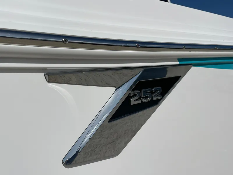 Slide: The Image of 2025 Blackfin 252CC boat emblem on sleek white hull. - 5