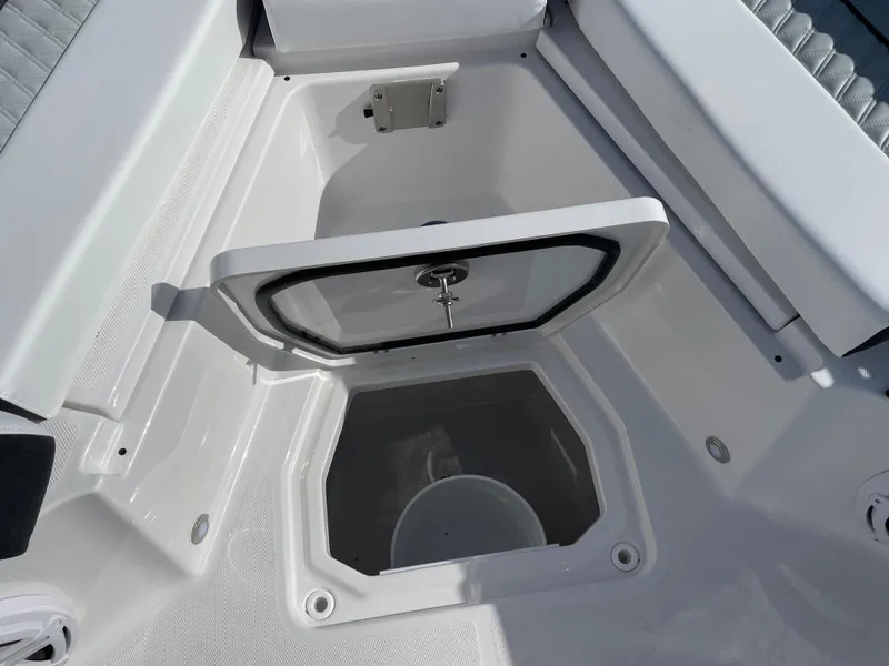 Slide: The Image of 2025 Blackfin 252CC boat storage compartment with open hatch, showcasing interior space. - 8