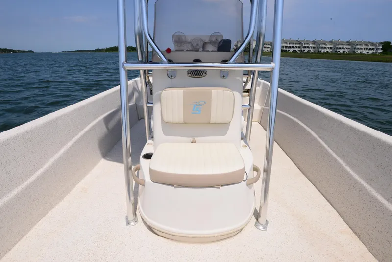 Slide: The Image of 2018 Carolina Skiff 218 DLV boat interior with seating and console on calm water. - 12