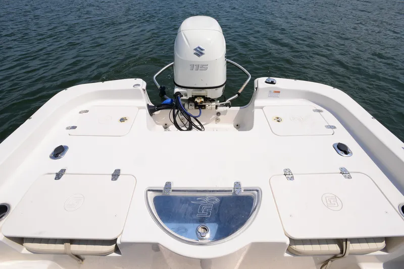 Slide: The Image of 2018 Carolina Skiff 218 DLV boat with Suzuki 115 outboard motor on water. - 17