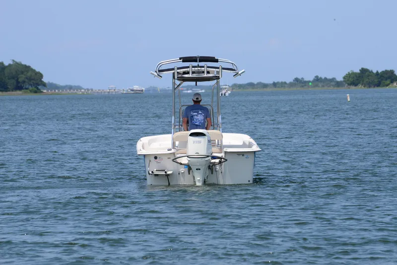 Slide: The Image of 2018 Carolina Skiff 218 DLV boat cruising on a calm lake. - 7