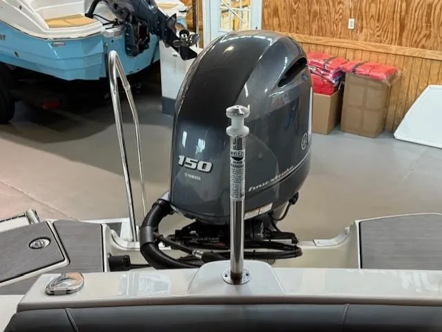 Slide: The Image of 2023 NauticStar 203 DC boat with Yamaha 150 engine in showroom. - 11