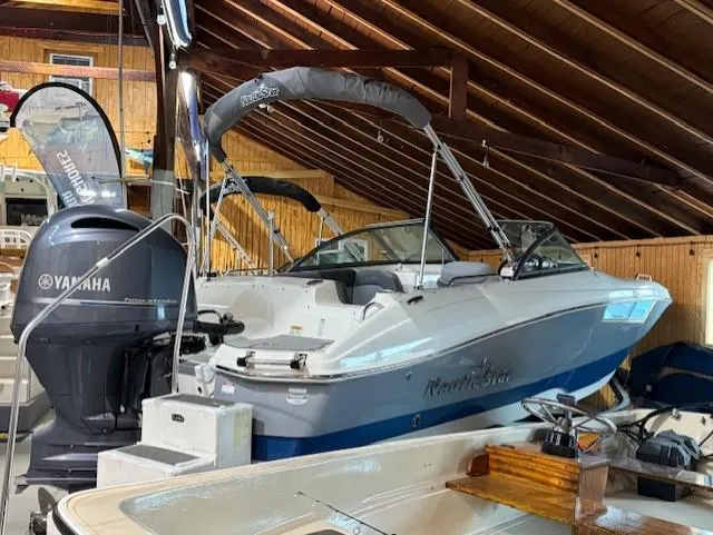 Slide: The Image of 2023 NauticStar 203 DC boat with Yamaha engine in wooden boathouse. - 2