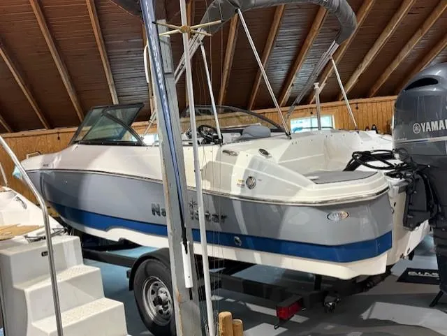 Slide: The Image of 2023 NauticStar 203 DC boat in storage, featuring Yamaha outboard motor. - 4