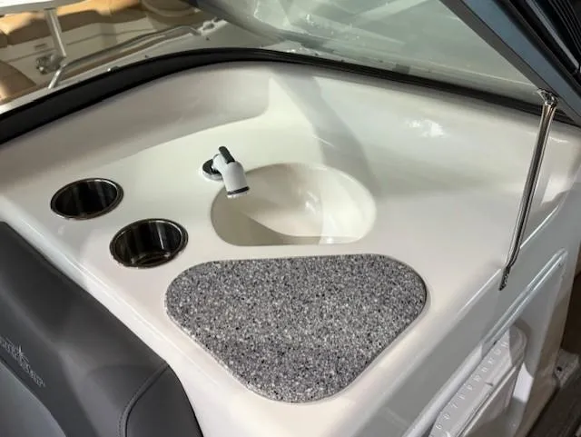 Slide: The Image of 2023 NauticStar 203 DC boat interior with sink and cup holders. - 8