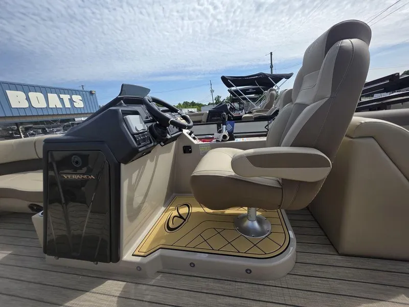 Slide: The Image of 2025 Veranda VR22RC Tri-Toon boat interior with captain's chair and control panel. - 11