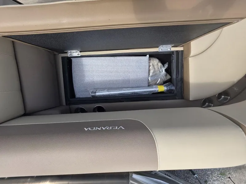 Slide: The Image of Interior storage compartment of 2025 Veranda VR22RC Tri-Toon boat with accessories. - 16