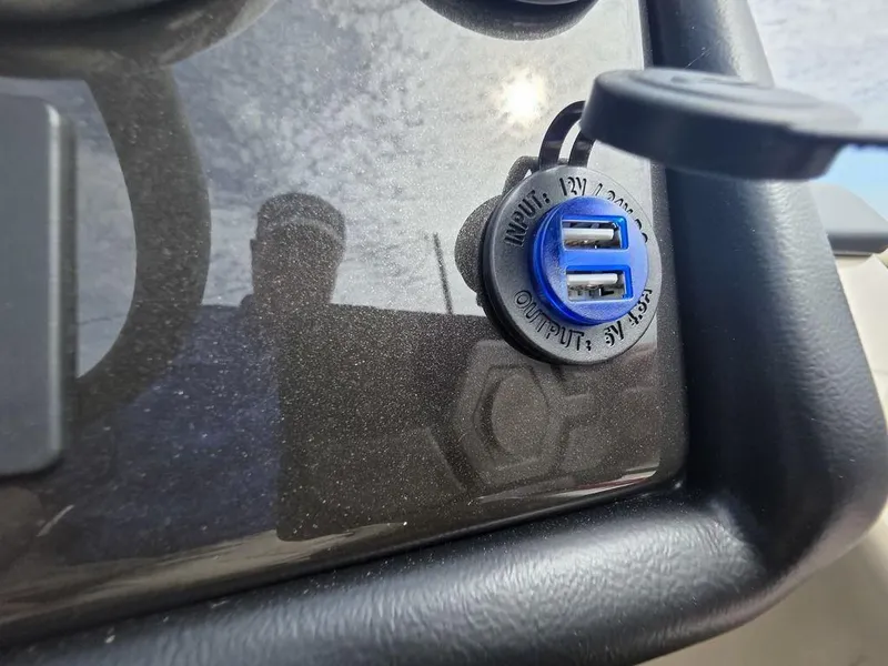 Slide: The Image of USB charging ports on a 2025 Veranda VR22RC Tri-Toon boat dashboard. - 17