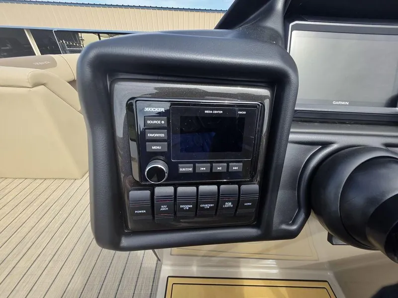 Slide: The Image of 2025 Veranda VR22RC Tri-Toon dashboard with Kicker media center and Garmin display. - 24