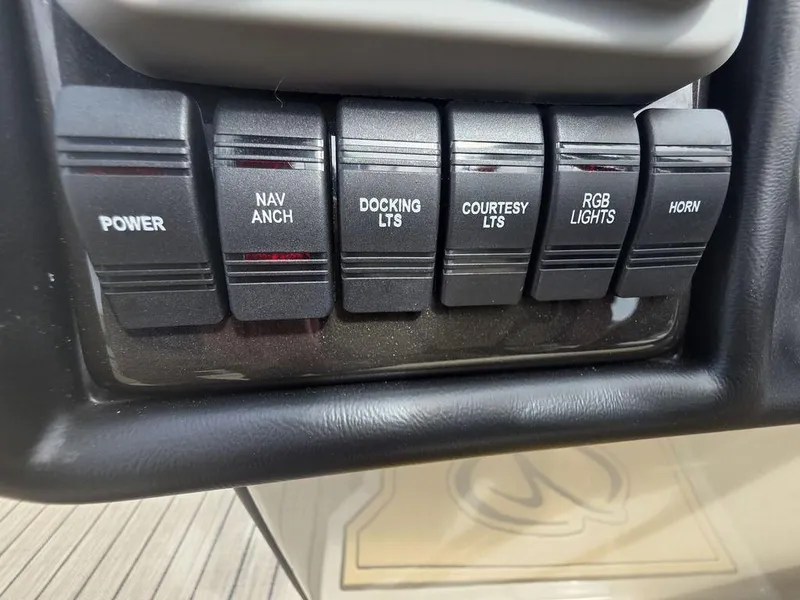 Slide: The Image of Control panel of 2025 Veranda VR22RC Tri-Toon with labeled switches for various functions. - 26