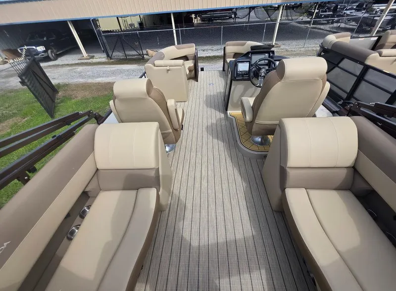 Slide: The Image of 2025 Veranda VR22RC Tri-Toon interior with beige seating and modern helm. - 27