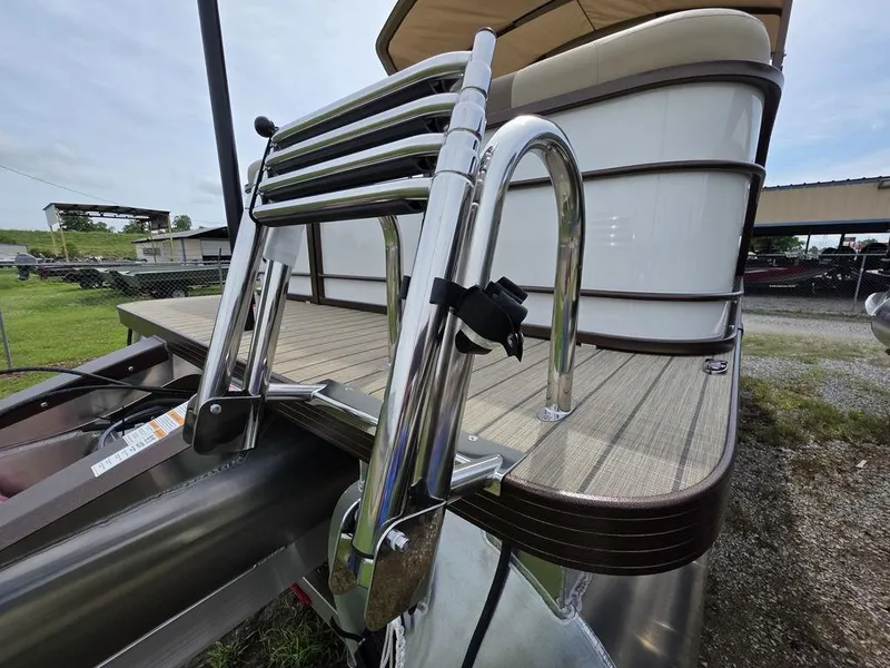 Slide: The Image of 2025 Veranda VR22RC Tri-Toon boat with stainless steel ladder and wooden deck. - 29