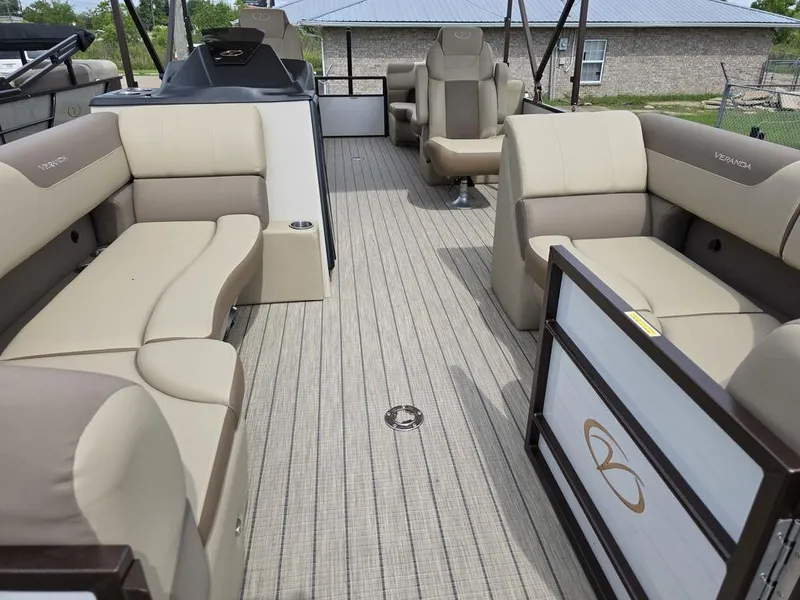 Slide: The Image of 2025 Veranda VR22RC Tri-Toon interior with beige seating and spacious deck layout. - 34